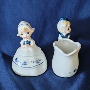 Vintage Enesco Little Dutch girl and boy sugar and creamer set.
